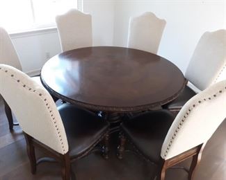 Hand carved round extendable dining table with 6 chairs