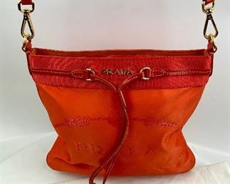 This Prada Orange cross body bag is available for purchase at:       https://scavengersparadiseestatesales.com