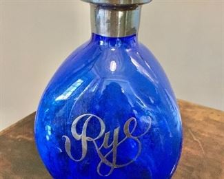 $50 - Vintage, cobalt decanter with dimpled sides and sterling "Rye" appliqué, silver rim (no obvious marks) and no stopper;  7 1/2 in. (H) x 4 1/2 in. (W)