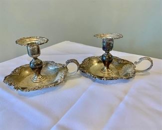 $175 - Pair Howard & Co. sterling silver candlesticks; 3 1/2 in. (H) x 5 1/2  in. (L, with handle) x 4 1/2 in. (W); 270 grams 