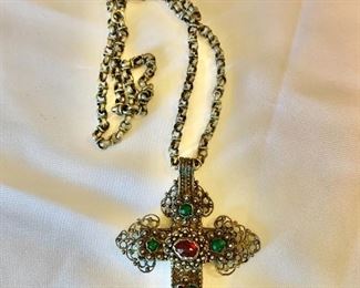$80 - Filigreed metallic cross with red and green glass decorations on chain; cross 3 1/2 in. (L) x 26 in. (chain length)