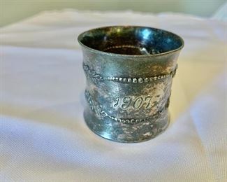 $10 - Antique napkin ring; monogrammed "WAM" and dated 1907; unmarked; 1 1/2 in. (W) x 2 in. (diameter)