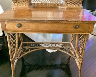 $140 - Vintage c. 1895/1915 desk with rattan legs, ornaments, and support; 36 in. (H, rear) x 34 in. (L) x 20 in. (depth) x 30 in. (floor to desktop) Needs some love!