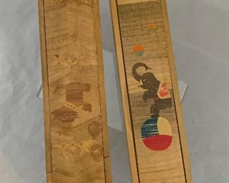 $20; Two decorative pencil boxes with sliding covers; dimensions: (box, left) - 1 1/2 in. (H) x 9 1/4 in. (L) x 2 1/4 in. (W); (box, right) - 1 in. (H) x 9 1/2 in. (L) x 2 1/4 in. (W)