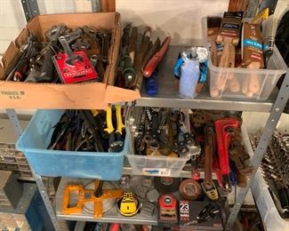 Dozens of wrenches, pliers, pipe wrenches, paint brushes, etc.