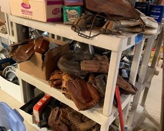 Vintage baseball gloves, ice skates, punching bag, baseballs, sports paraphernalia