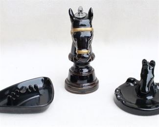 $20 Center: Horse head chess piece cigarette lighter, black ceramic with gold trim.  W: 3.5" | H: 8" | D: 4.5"
$15 Left: Black plastic triangular ashtray.  W: 7" | H: 1" | D: 5"
Right: Black ceramic ashtray, horsehead & horseshoe motif.  W: 5" | H: 4.5" | D: 5" [Bin 41]
