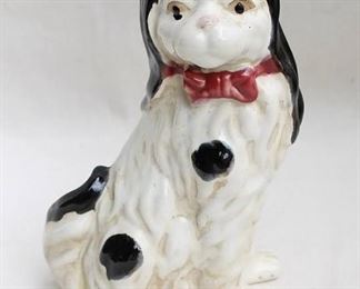 $40 Glazed ceramic spaniel, mantel ornament, black/white with red bow.  W: 8" | H: 11" | D: 4.5" [Props]
