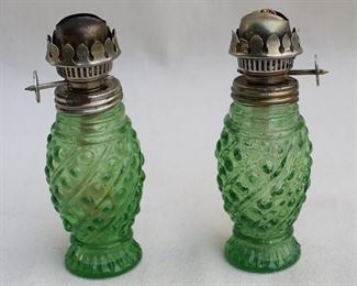 $40 Set of 2 green pressed glass kerosene lamps, metal mounts, glass shades missing.  H: 5" |  diameter: 2" [Bin 38]