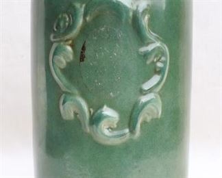 $45 - Green-glazed cylindrical ginger jar, raised cartouche on one side, hinged brass lid.  H: 14" |  diameter: 6.5"