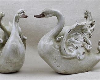 $40 Set of 2 ceramic swans, antiqued crackled cream finish, breasts embossed w/ symbols.  L: 14" | W: 5" | H: 10.5" AS IS: one tail mended [Props]