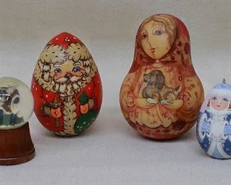 LOT $50 Left to right:
- Santa snow globe w/ wooden base. Made in Taiwan.  H: 3" | globe diameter: 1.5" 
- Painted wooden Santa, egg-shaped. Russian.  H: 4.5" |  diameter: 2.5"
- Painted wooden bell, gourd shape, depicts peasant girl holding a dog. Russian.  H: 5" | diameter: 3"
- Painted Snow Queen ornament w/ hanger, egg-shaped. Russian.  H: 2.5" | diameter: 1.5" [Bin 32] 