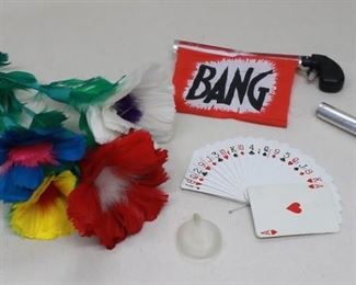 $20 Lot of magician's props: 3 multi-colored feather flowers & leaves, connected to a single ring (L: 16");   
deck of playing cards connected together for magic tricks (L: 3.5" | W: 2.5");  2 derringers w/ spring-loaded "Bang" banner, made of metal, plastic, & fabric (L: 5" |  extended: 9");  clear plastic pneumatic. [Bin 32] 