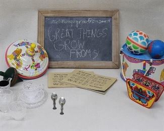 Lot of children's toys:
New painted tin drum w/ carrying cord (H: 4.5" | diameter: 8");   new painted tin plunger top (H: 7.5" | diameter: 7");  vintage wooden top (AS IS string missing)(H: 4.5" | diameter: 3");  new toy accordion, brightly colored (L: 5" | W: 3.5" | D: 1.5");  blackboard, $20 blackboard, slate w/ unfinished wood frame (L: 14" | W: 10" | D: 0.5");  2  calligraphy books, paperback (L: 7.5" | W: 5");  doll's tea set of plastic pressed glass (10 pieces);  2 colorful rubber balls (diameter:  3.5"and 3"). [Bin 32]