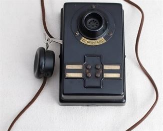 $25 Vintage inter-office wall-mounted telephone, black celluloid, earpiece on 41" cord, 4 buttons.  W: 6.5" | H: 7.5" | D: 4" [Bin 31] 