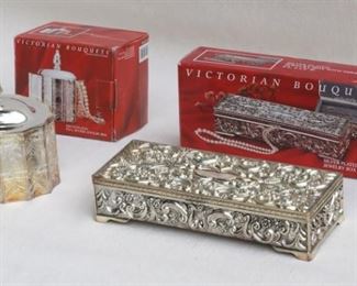 $40 LOT Left: Silver plate "Paul Revere" jewelry box, incised design, separate lid w/ finial, red velvet-lined,  Victorian Bouquets by Godinger Silver, in box, made in China.  L: 4.5" | W: 4" | H: 3" | height w/ lid: 5.5".  Right: Silver plate oblong jewelry box, ornate repoussé, hinged lid w/ mirror, gray velvet-lined compartments, Victorian Bouquets by Godinger Silver, in box, made in China.  L: 9" | W: 4" | H: 2"  [Bin 26] 