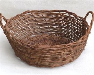 $20 Basket handwoven of vines, 2 handles of twisted vines.  W: 21" | H: 9.5" | diameter: 18.5" [Bin 26] 