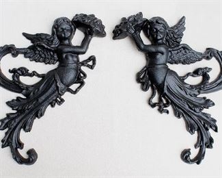 $60 for set of 2 black cast metal wall plaques, winged cherubs emerging from foliage, holding heaped platters, hanger on backs.  W: 11" | H: 13" | D: 1.5" [Bin 24]