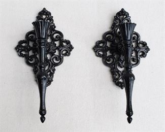 $80 - Set of 2 black cast metal wall sconces for a single candle, shiny, hanger on back.  W: 5.5" | H: 11" | D: 4" [Bin 25] 