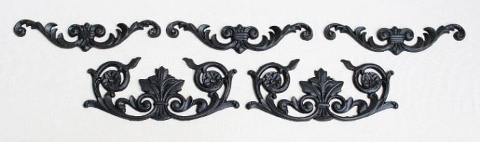 $45 - LOT Upper: Set of 3 black cast metal wall plaques, floral design, 2 holes for hanging.  W: 12" | H: 2.5" | D: 0.5" 
Lower: Set of 2 black cast metal wall plaques, floral design, 2 holes for hanging.  W: 12" | H: 5" | D: 0.5" [Bin 24] 