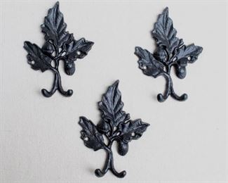$30 - Set of 3 black cast metal wall hooks, each with 3 leaves and 2 acorns, 2 stubby hooks each, 2 holes for hanging.  W: 4.5" | H: 6" | D: 1" [Bin 24]