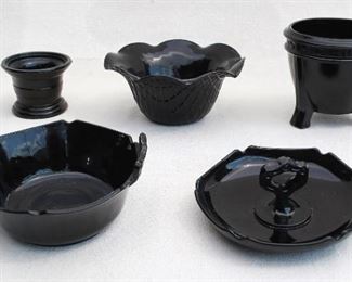 $60 - LOT Rear left: Black-glazed ceramic columnar vase/bowl. 
H: 2.5" | diameter: 3"
Rear center: Black-glazed ceramic flared bowl, scalloped edge.  H: 3" |  | diameter: 6.5" 
Rear right: Black-glazed ceramic footed bowl.  H: 4" |diameter: 4.5"
Front left: Black-glazed ceramic bowl w/ 2 handles.  L: 6.5" | H: 3" | D: 6"
Front right: Black-glazed ceramic candy dish with central handle.  H: 3" | diameter: 6" [Bin 19] 
