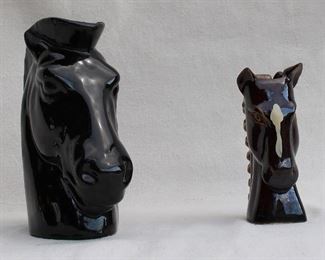 $30 - LOT Left: Black-glazed ceramic horsehead vase.  L: 8" | W: 3.5" | H: 8.5" 
Right: Black-glazed ceramic horsehead vase, horse has white blaze, curly mane of a lighter color.  L: 3.5" | W: 3" | H: 6" [Bin 19] 