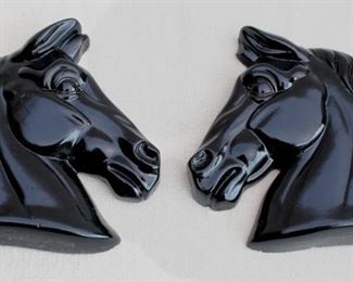 $24 - Set of 2 black-glazed ceramic horsehead wall plaques.  W: 5.5" | H: 6" | D: 1" [Bin 19] 