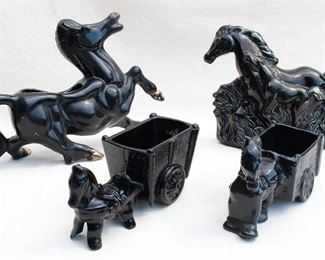 $50 - LOT Rear left: Black ceramic horse vase, gold trim.  L: 14.5" | W: 6" | H: 10" 
Rear right: Vintage ceramic wall sconce shaped like two horses running through grass, black glaze, for single bulb, light directed upwards to ceiling.  L: 12" | H: 9" | D: 5" - AS IS see chip on back in detail photo
Front left: Black ceramic horse & cart.  L: 8" | W: 3.5" | H: 5.5" 
Front right: Black cast metal horse & cart.  L: 9.5" | W: 3" | H: 4.5" [Bin 19] 