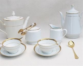 $40 - LOT Noritake Richmond pattern:
- White porcelain teapot w/ gold trim.  W: 10" | H: 8" | D: 5.5"
-White porcelain coffee pot w/ gold trim.  W: 8.5" | H: 9" | D: 5" 
- White porcelain creamer w/ gold trim.  L: 5" | W: 3" | H: 4"
- White porcelain sugar bowl w/ gold trim |  |  |  | H: 5" |  | diameter: 4" |  | Made in China | 
- 2 white porcelain cups & saucers w/ gold trim.  H: 2.5"  | saucer diameter: 6"
- Brass sugar spoon.  L: 6.5" | W: 1.5"
- Brass sugar tongs.  L: 5" [Bin 18] 