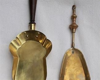 $40 - LOT Left: Brass fireplace shovel, short wooden handle.  L: 14" | W: 6.5" 
Right: Brass fireplace shovel, ring for hanging.  L: 12" | W: 4.5" [Bin 15] 