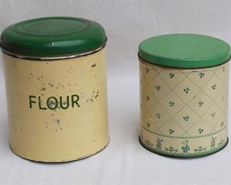 $20 - Left: vintage flour canister, cream & green.  H: 8.5" | diameter: 7.5"
Right: Vintage unlabeled canister, windmill decoration.  H: 6.5" | diameter: 6" [Bin 12C] 