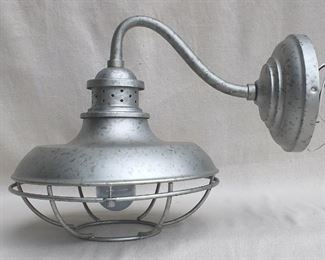 $40 - Wall-mounted metal light fixture, distressed aluminum finish, cage for bulb, new & never used.  W: 12" | H: 13" | D: 17" | diameter of base: 7" [Bin 11C] 