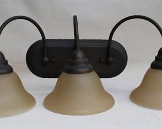 $40 - Wall sconce, bronze finish, 3 lights with frosted bell-shaped globes.  W: 24" | H: 9" | D: 9" | globe diameter: 7" 