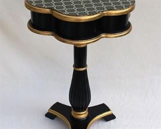 $120 - Wood pedestal table, dark stain w/ gold trim, fluted pedestal w/ 3 feet, 6-lobed top w/ protective mat glued on.  H: 24.5" | diameter: 16" 