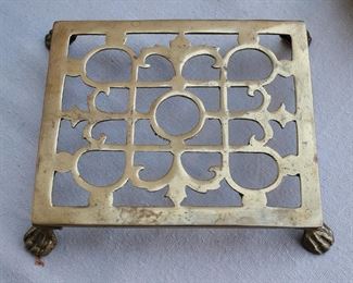 $20 - Cast brass trivet, 4 feet.  L: 9" | W: 8" | H: 1.5"   [Bin 7B]