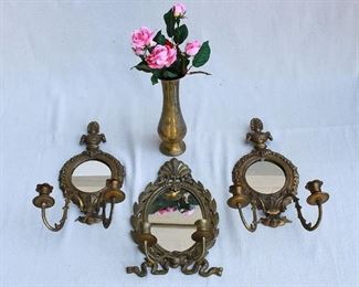 $50 - LOT- Incised brass vase containing artificial pink roses.  H: 9.5" 
Center: Mirrored wall sconce for 2 candles.  W: 8" | H: 13.5" 
Right and left: pair of mirrored wall sconces, each for two candles.  W: 8.5" | H: 16.5" [Bin 7A] 