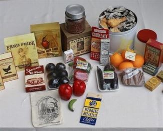 $60 - LOT of vintage fake food & kitchen supplies: items for washing (soap, starch) (7); boxes of cereal (5); boxes of meal/flour (5); bag of coffee (1); box of maple flavoring (1); pkgs of shrink-wrapped vegetables (3); red apples (2); small green banana (1); net bag of 4 oranges (1); slices of pumpernickel bread (2); jar of dried beans (1); milk glass jar w/ red metal top (1); large white tin of fried chicken (1).  [Bin 6 