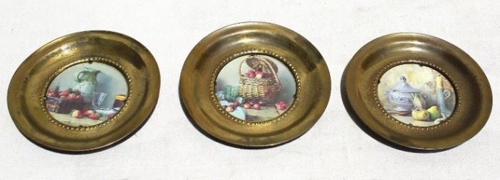 $25 - Set of 3 picture plates: Still life scenes in round brass frames, self-hangers.  W: 6" | D: 0.5" [Props] 