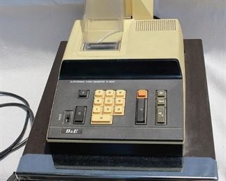 Vintage cash register, yellow and black, electronic , B&E. 
W: 12.5" | H: 11" | D: 17"  AS IS: Minor damage to plastic cover  [Props] 