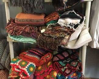 Huge selection of throws (small blankets) of every fabric and weave.  Crocheted group on lower shelf