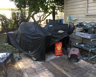 Two barbeque set-ups--one gas and one charcoal