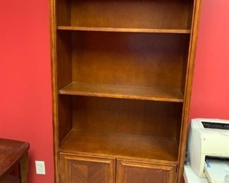 #153	wood bookcase with 2 shelves and 2 doors 33x15x76	 $100.00 
