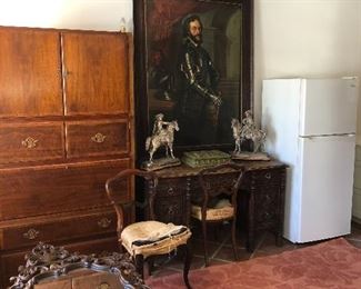 Large painting of a man in a suit of armor, Amazing English Renaissance - carved with grapes perfect for a winery  partners desk,  small kitchen refrigerator 24" W X 60" H, mirrors - side tables, beautiful rosewood framed antique chairs - need upholstery.  Very large Baker cabinet - is 3 interlocking cabinets.