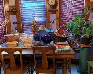 Large selection of baskets, rubber tree plant, decorative elements.
