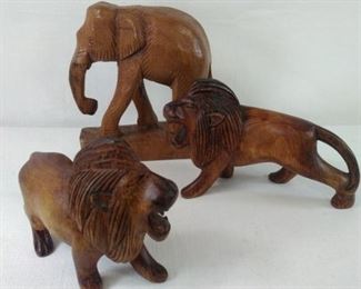 hand carved wooden lions and elephant