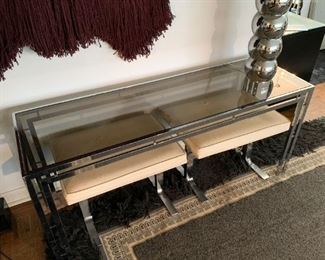 LOT #103 - $650 - Vintage Chrome & Smoky Glass Console Table with 2 Upholstered Stools (table approx. 59.5" L x 22" W x 26" H, upholstery on stools needs cleaning) 