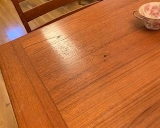 Very nice mid century dining table and four chairs. Table has hidden expandable leaves. 