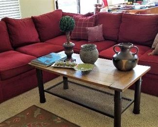 Deep red sectional sofa. Not too big and can fit in so many places. Rustic coffee table.