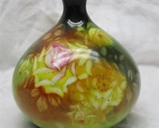 hand painted ceramic vase was manufactured in Germany by Franz Mehlem's Royal Bonn factory. I believe it dates to the late 1800's - early 1900's.  
It stands 5-1/8" in height.   Rose Motif there is a small glaze nick on the side